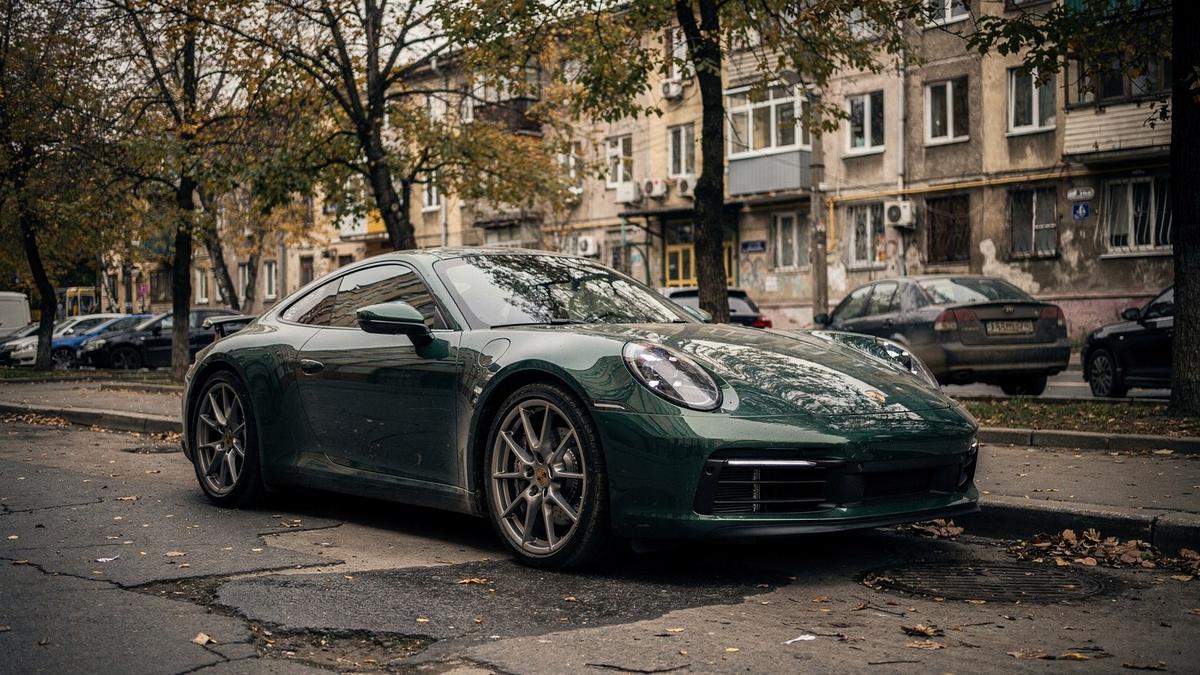 Dark green 2020 Porsche 911 Carrera S parked on a quiet street in Kyiv